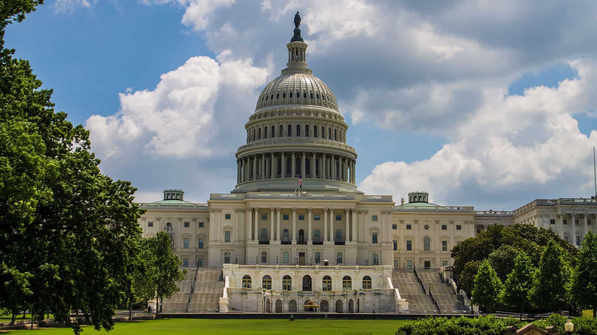 Washington D.C. Capitol building with blue sky and clouds.